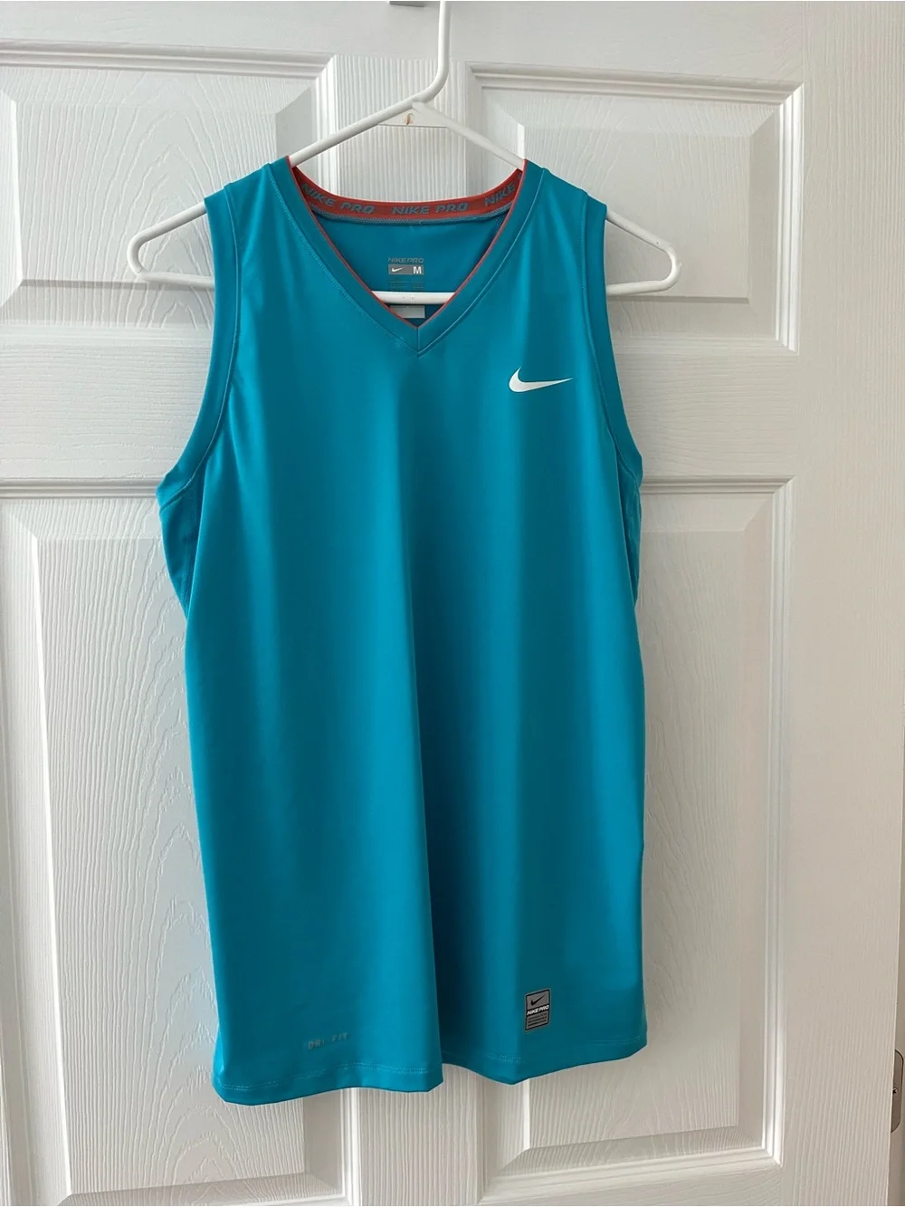 Nike women’s Teal Sleeveless Top with White Swoosh